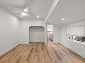 Discover this charming bedroom featuring a modern ceiling fan and recessed lighting for optimal ambiance.