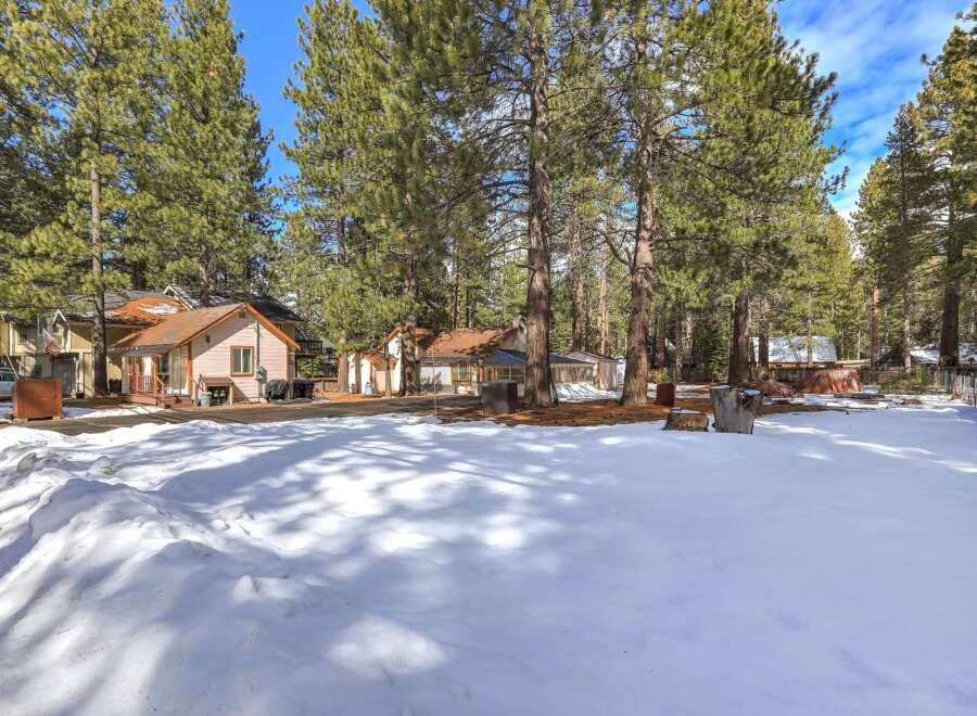 Nestled among tall pine trees, this property offers a serene mountain escape.