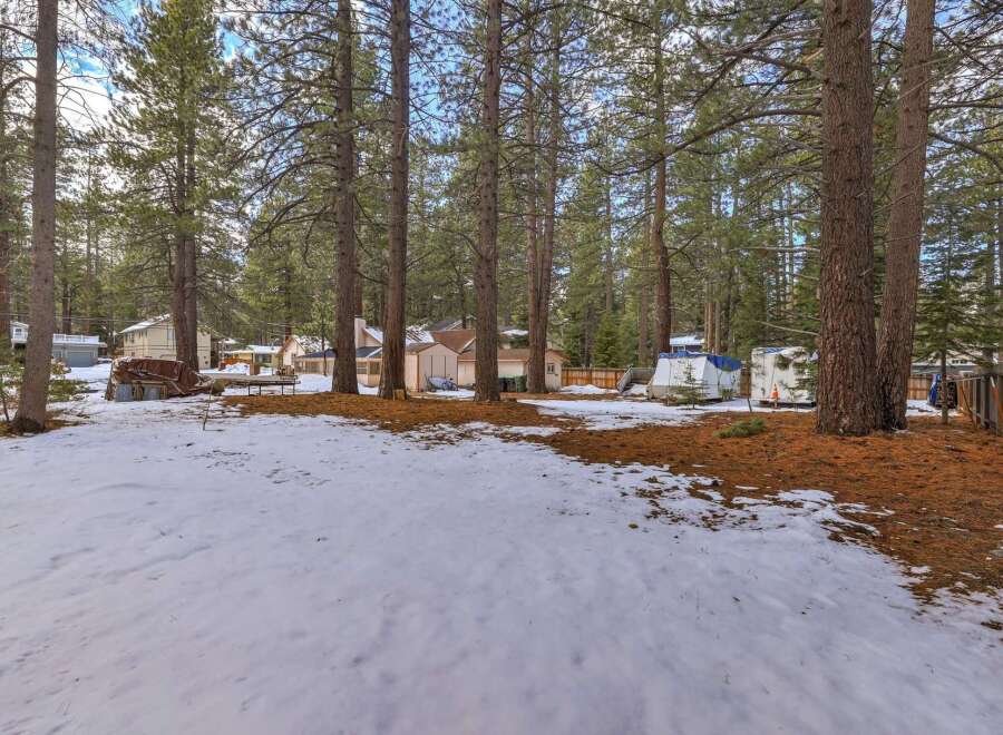 Discover this charming property nestled among tall pine trees, offering a serene and private setting.