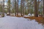 Discover this charming property nestled among tall pine trees, offering a serene and private setting.