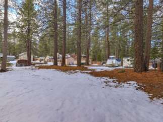 Discover this charming property nestled among tall pine trees, offering a serene and private setting.