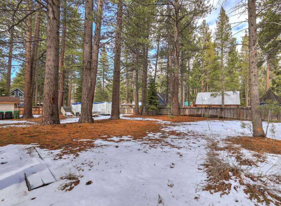Discover this charming property nestled among tall pine trees, offering a serene and private setting.