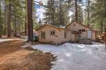 Nestled among tall pine trees, this charming property offers a serene retreat with a private hot tub perfect for relaxation.