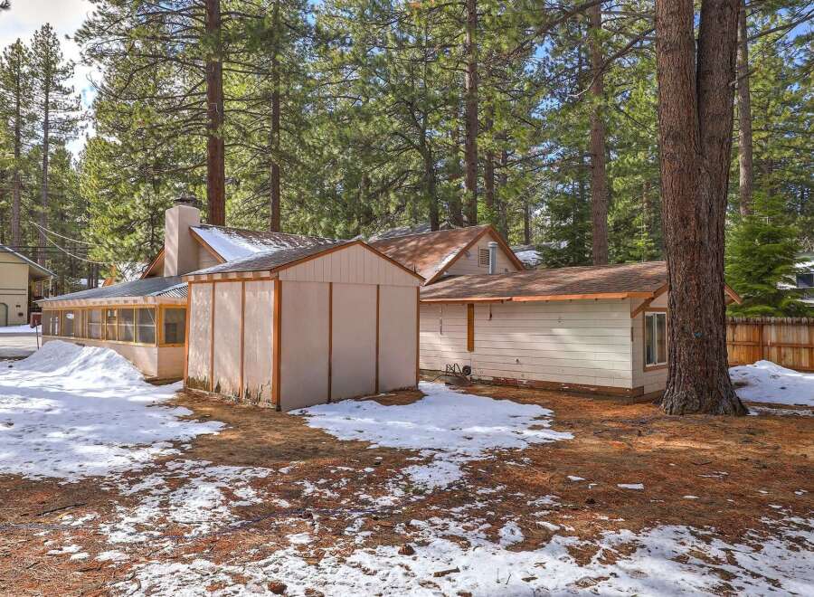 Nestled amongst tall pine trees, this property offers a unique blend of rustic charm and potential.