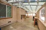 Discover the potential of this versatile sunroom, perfect for a workshop or greenhouse.