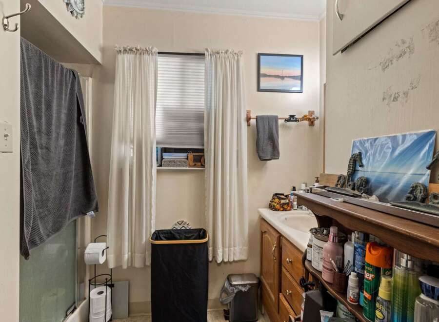This bathroom offers a functional and organized space with ample storage.