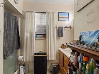 This bathroom offers a functional and organized space with ample storage.