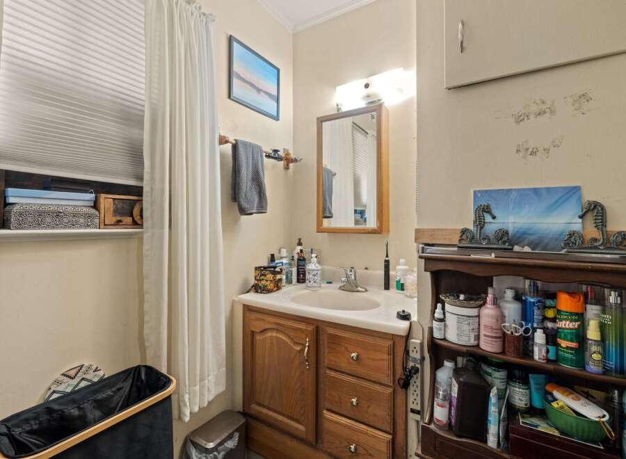 Discover this charming bathroom featuring a spacious vanity with ample storage, perfect for organizing all your essentials.