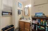 Discover this charming bathroom featuring a spacious vanity with ample storage, perfect for organizing all your essentials.