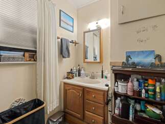 Discover this charming bathroom featuring a spacious vanity with ample storage, perfect for organizing all your essentials.