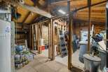 This spacious storage area offers ample room for all your belongings, featuring a water heater and a variety of paint and cleaning supplies.
