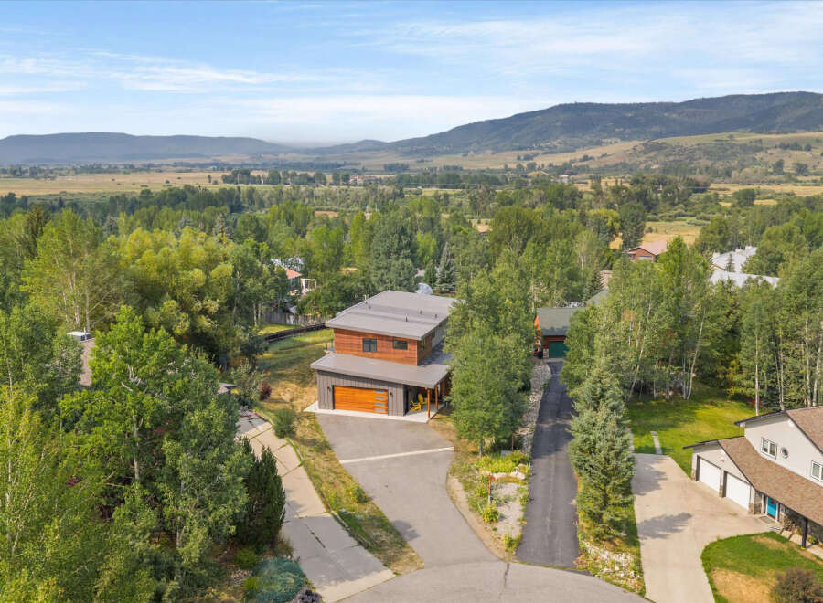 Discover this stunning modern home nestled amidst lush greenery and rolling hills.