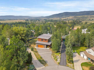 Discover this stunning modern home nestled amidst lush greenery and rolling hills.