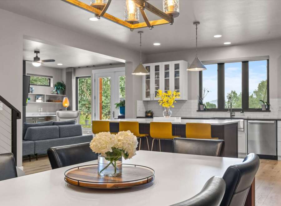 Experience modern living in this open-concept home, featuring a spacious dining area perfect for entertaining and a sleek kitchen with a large island and bar seating.
