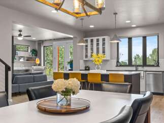 Experience modern living in this open-concept home, featuring a spacious dining area perfect for entertaining and a sleek kitchen with a large island and bar seating.