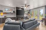 Experience modern living in this stunning living room, featuring a sleek fireplace and a large flat-screen TV.