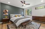 Experience modern comfort in this beautifully appointed bedroom, featuring a plush king-sized bed with crisp white linens and accent pillows.