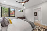 This modern bedroom features a large window offering scenic views of the outdoors.
