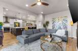 Experience modern open-concept living in this stunning home, featuring a sleek kitchen with a central island and a spacious living area perfect for entertaining.