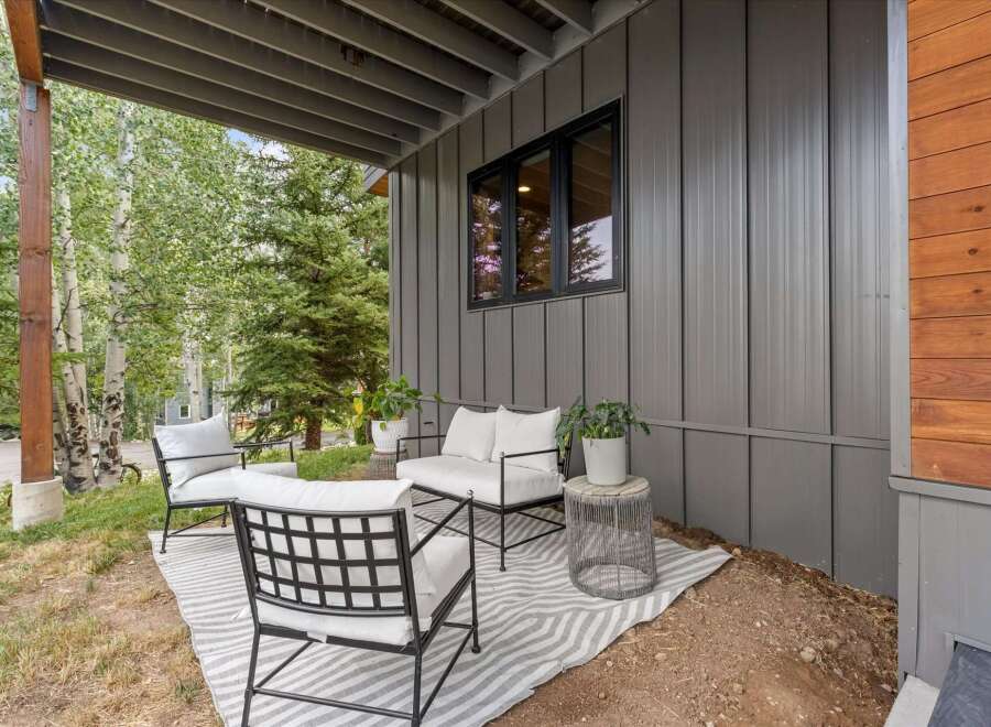 Enjoy the serene mountain setting from this charming covered patio, perfect for relaxing outdoors.