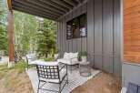Enjoy the serene mountain setting from this charming covered patio, perfect for relaxing outdoors.