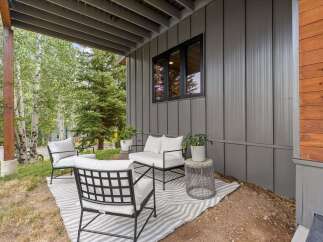 Enjoy the serene mountain setting from this charming covered patio, perfect for relaxing outdoors.