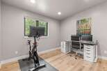 This modern home office features a Peloton bike for your workouts and a spacious desk with dual monitors for productivity.