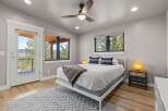 Experience mountain living in this charming bedroom featuring a comfortable queen-size bed adorned with decorative pillows and a cozy throw blanket.