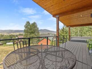 Enjoy breathtaking mountain views from this expansive deck, perfect for outdoor entertaining or quiet relaxation.