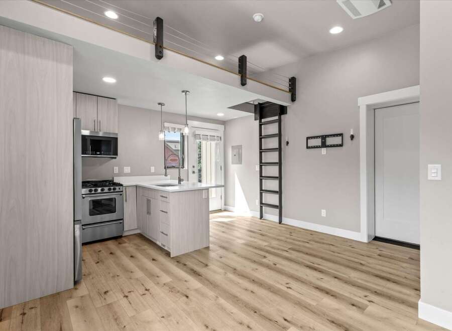 Discover modern living in this stylish studio apartment featuring a sleek, contemporary kitchen with stainless steel appliances and a convenient island.