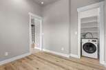 Discover modern convenience in this home featuring a dedicated laundry closet equipped with a sleek, front-loading washing machine.
