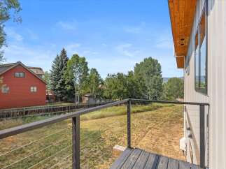 Enjoy the stunning mountain views from this modern home's private balcony, featuring sleek cable railings.