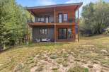 Discover modern living in this stunning two-story home, featuring a striking combination of wood and dark siding.