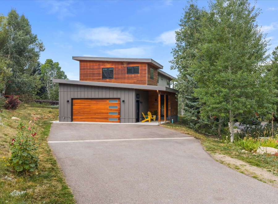 Discover modern mountain living in this stunning home featuring a striking wood and metal exterior.