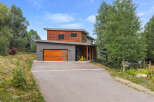 Discover modern mountain living in this stunning home featuring a striking wood and metal exterior.