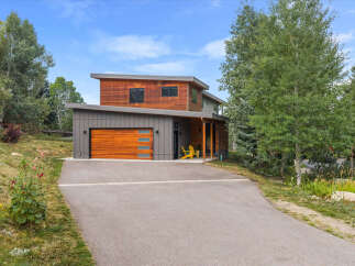 Discover modern mountain living in this stunning home featuring a striking wood and metal exterior.