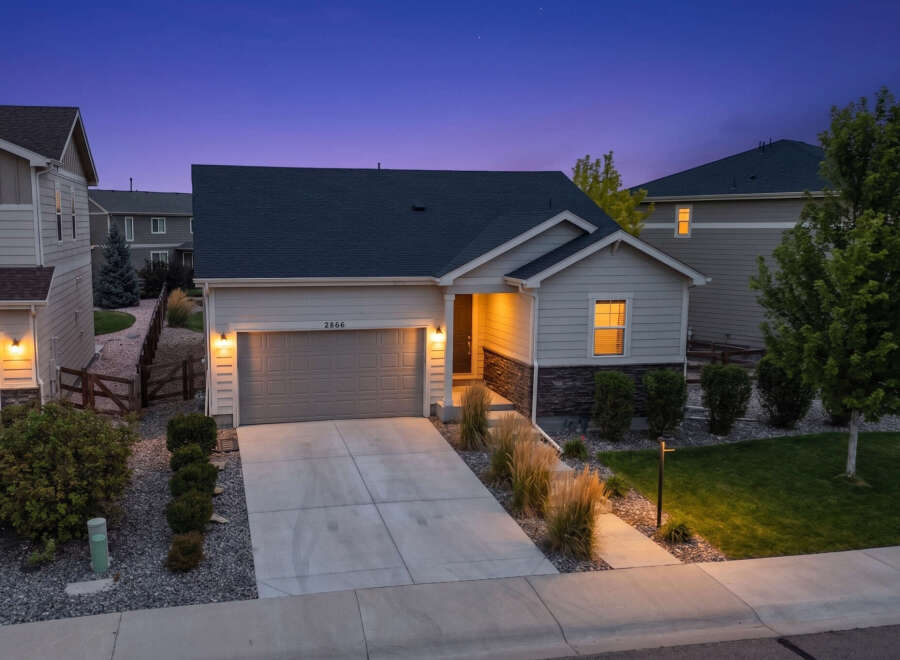 This charming single-family home features a welcoming facade with a well-maintained lawn and landscaping.