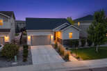 This charming single-family home features a welcoming facade with a well-maintained lawn and landscaping.