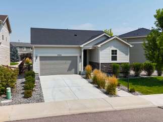 Discover this charming single-family home featuring a modern gray garage door and a welcoming light-colored exterior.