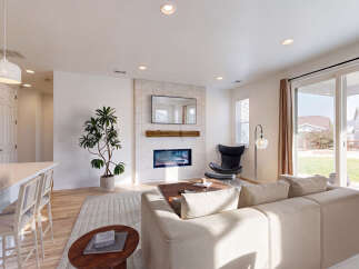 Experience modern living in this spacious great room, featuring a sleek fireplace with a tiled surround and a mounted television.