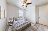 This inviting bedroom features a comfortable queen-size bed with a stylish wooden headboard, complemented by two matching nightstands and lamps.