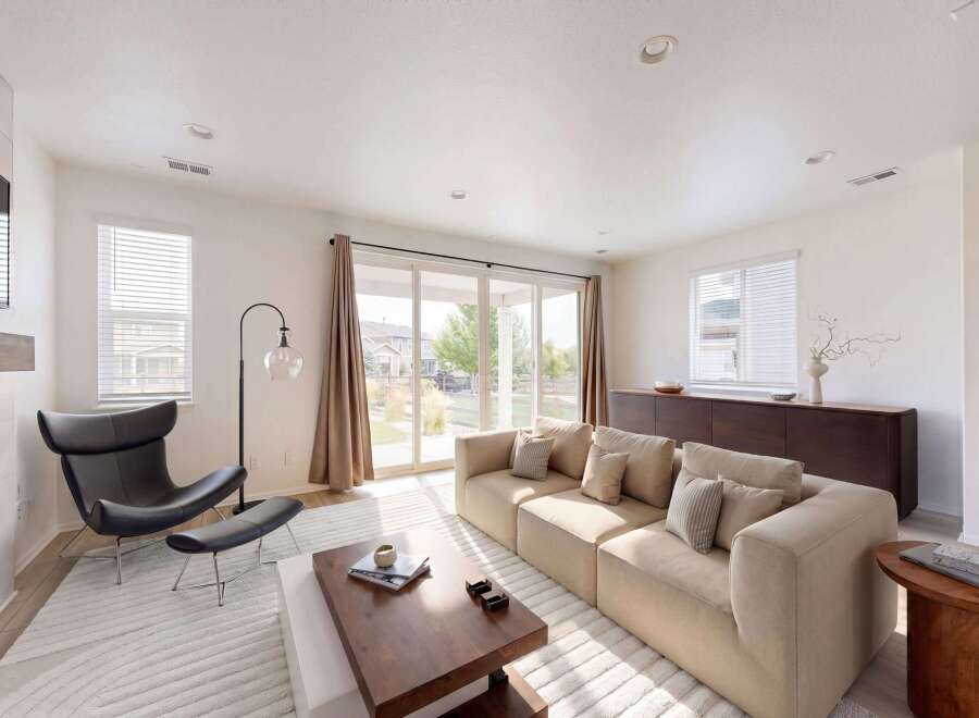 Experience modern living in this spacious living room, featuring a plush sectional sofa perfect for relaxation and entertaining.