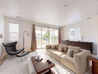 Experience modern living in this spacious living room, featuring a plush sectional sofa perfect for relaxation and entertaining.