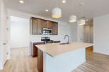 Experience modern living in this stunning kitchen featuring a spacious island with a sleek faucet and sink.