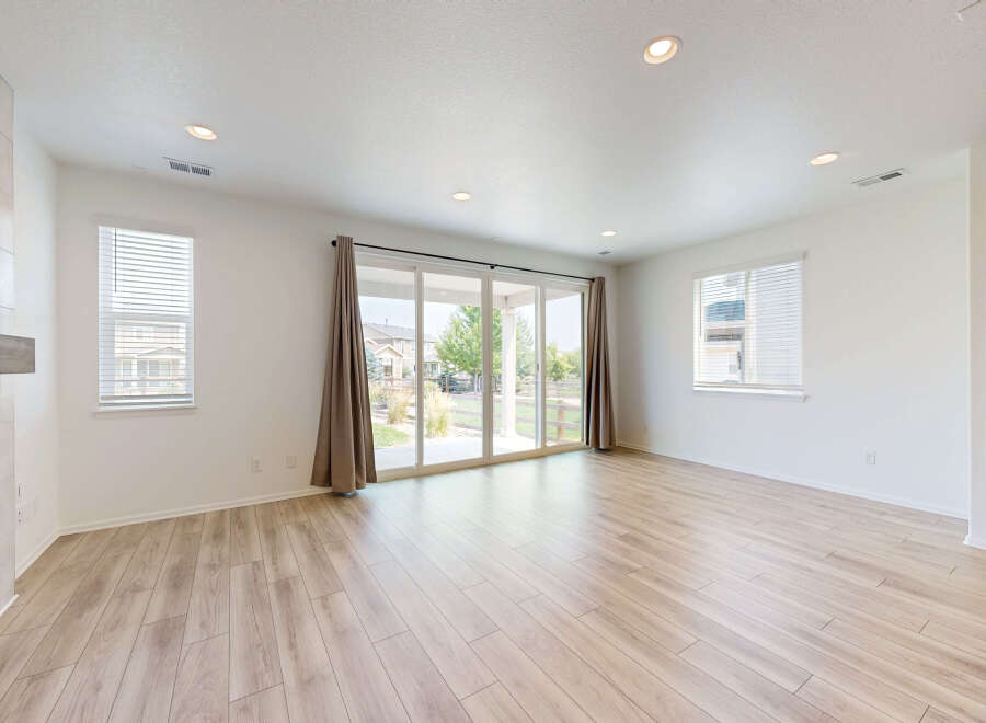Step into this bright and airy living space, featuring gleaming hardwood floors and abundant natural light.