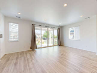 Step into this bright and airy living space, featuring gleaming hardwood floors and abundant natural light.
