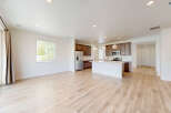 Experience modern living in this spacious open-concept home, featuring a sleek kitchen with a large island and ample cabinet space.
