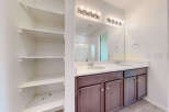 This spacious bathroom features a double vanity with two sinks and ample counter space, perfect for busy mornings.