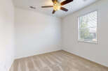 This empty bedroom features neutral beige carpeting and clean white walls, creating a blank canvas for your personal style.