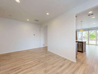 Experience modern living in this spacious home featuring an open-concept layout with gleaming hardwood floors.
